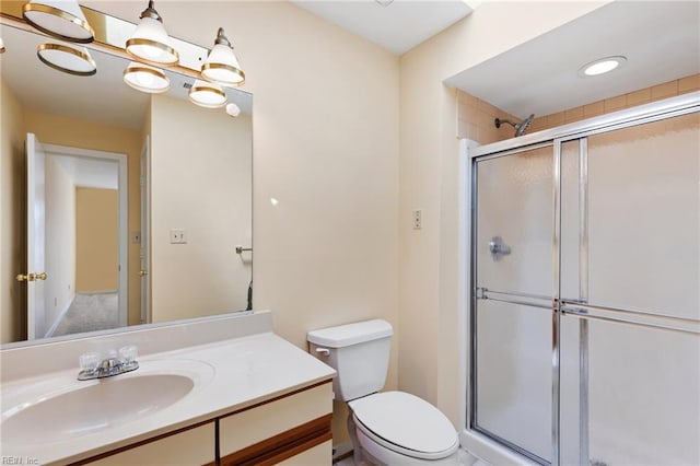 full bath with vanity, toilet, and a stall shower