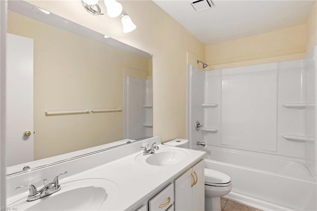 bathroom with a sink, double vanity, toilet, and visible vents