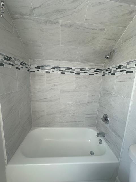 bathroom with shower / tub combination and toilet