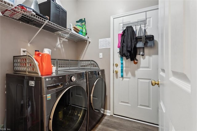 laundry room with washer and dryer, wood finished floors, and baseboards