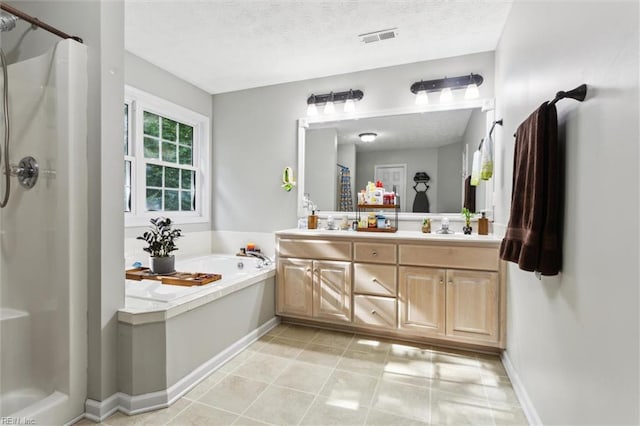 bathroom with a stall shower, a bath, double vanity, baseboards, and a textured ceiling