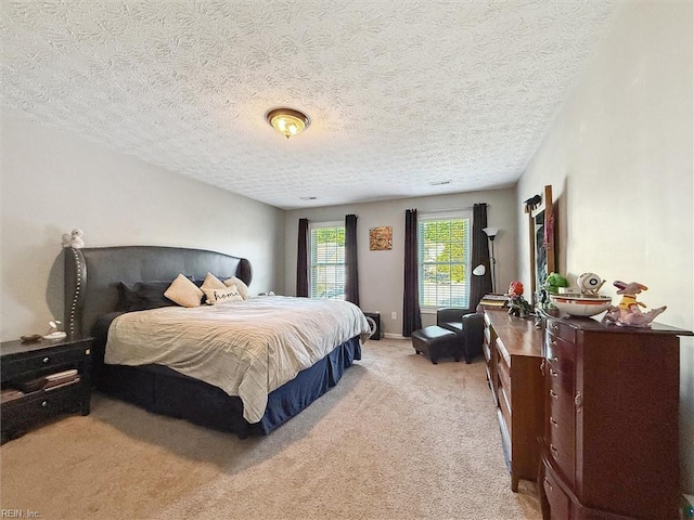 carpeted bedroom featuring a textured ceiling