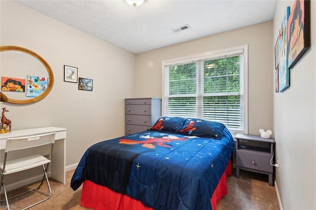 carpeted bedroom with a textured ceiling and baseboards