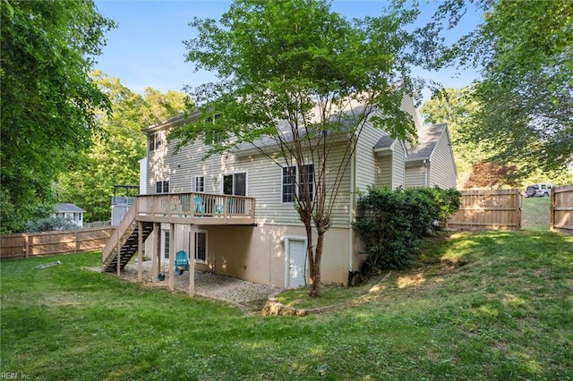 rear view of property with stairs and a wooden deck