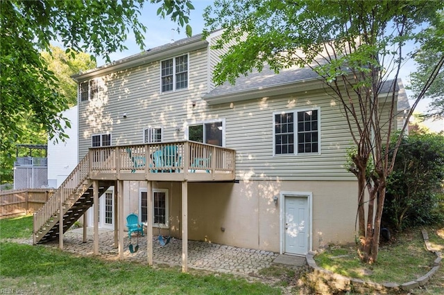 rear view of house featuring stairs, a deck, and a patio
