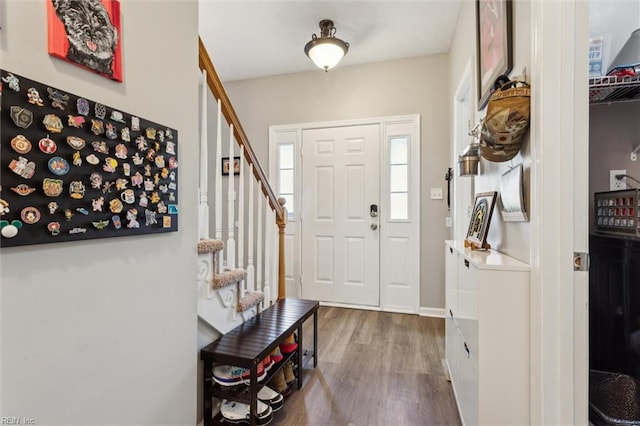 foyer entrance featuring wood finished floors and stairs