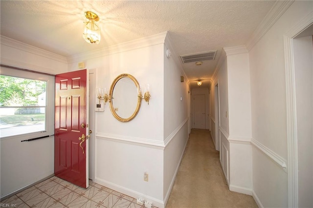 entrance foyer featuring baseboards, visible vents, and a textured ceiling