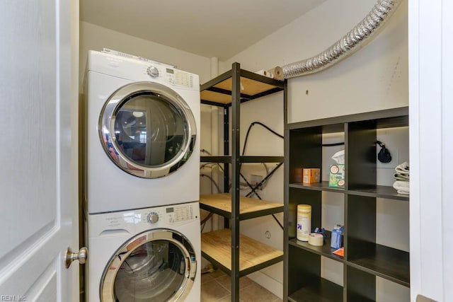laundry area featuring laundry area, stacked washer and dryer, and tile patterned floors