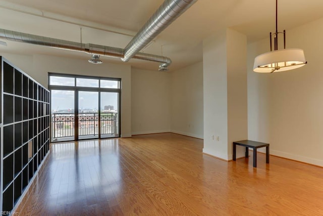 empty room with baseboards and wood finished floors