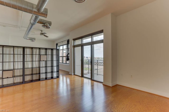 empty room with baseboards and wood finished floors