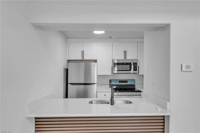 5117 Walkers Grant Ln Unit A, Virginia Beach, VA 23455 - kitchen featuring white cabinets, a sink, light countertops, stainless steel appliances, and visible vents