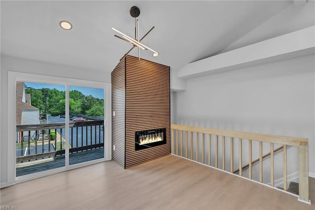 5117 Walkers Grant Ln Unit A, Virginia Beach, VA 23455 - empty room featuring a notable chandelier, a large fireplace, wood finished floors, and lofted ceiling