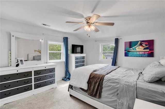 bedroom featuring visible vents, a ceiling fan, carpet, and multiple windows