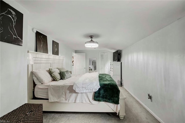 carpeted bedroom featuring baseboards