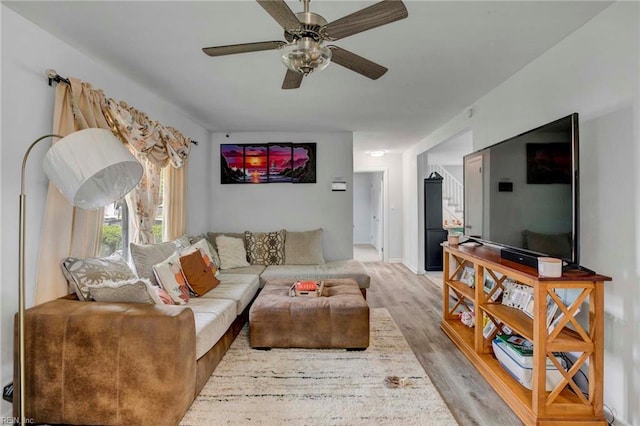 living area featuring a ceiling fan and light wood-style flooring