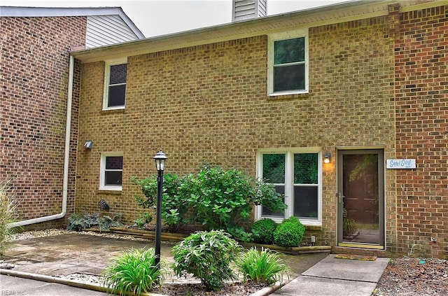 exterior space featuring a patio area and brick siding