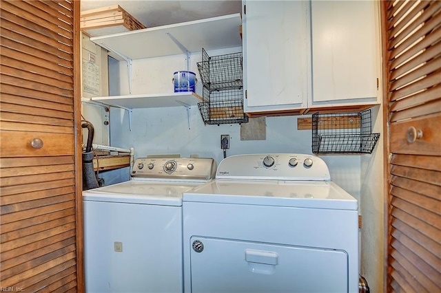 clothes washing area with cabinet space and washer and clothes dryer