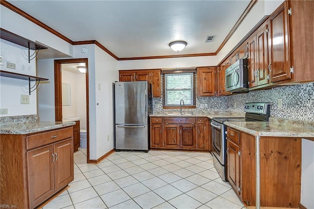 kitchen featuring stainless steel appliances, brown cabinetry, and a sink
