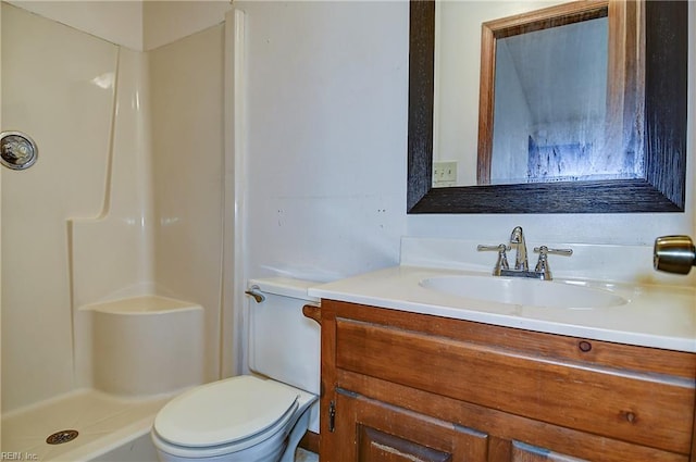 full bathroom with a shower stall, vanity, and toilet