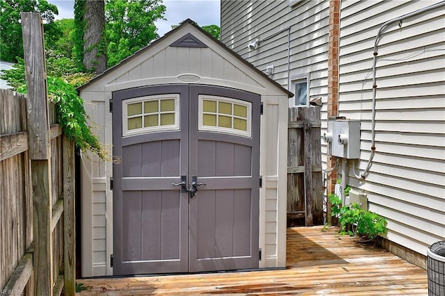 view of shed featuring fence