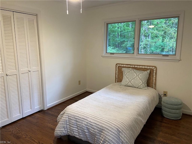 bedroom featuring baseboards, a closet, and wood finished floors