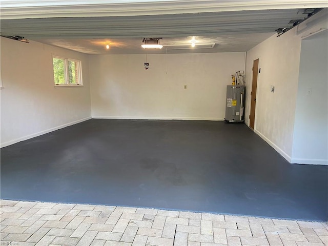 garage featuring electric water heater and baseboards