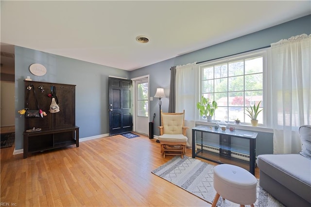 living area featuring wood finished floors and baseboards