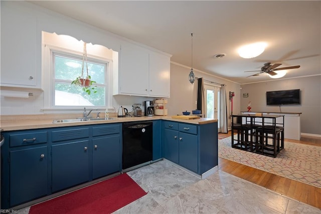 kitchen featuring dishwasher, blue cabinets, a sink, ornamental molding, and a peninsula