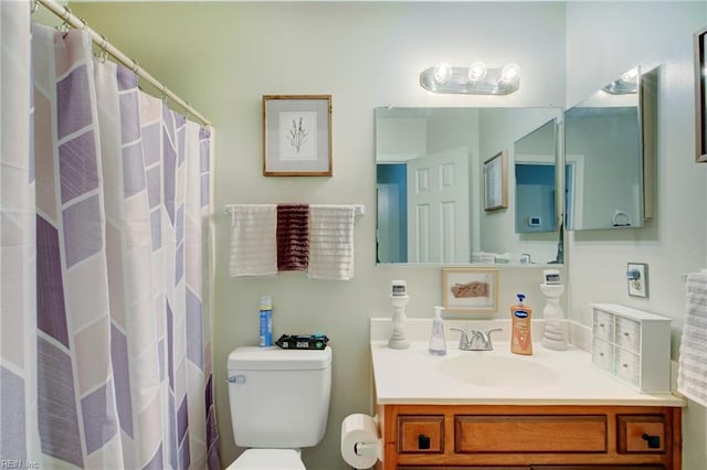 bathroom with toilet and vanity