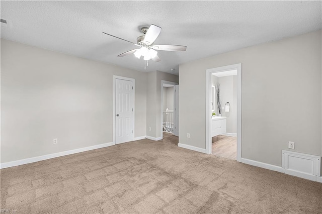 390 Naval Base Rd, Norfolk, VA 23505 - unfurnished bedroom featuring carpet, a textured ceiling, baseboards, ceiling fan, and ensuite bath