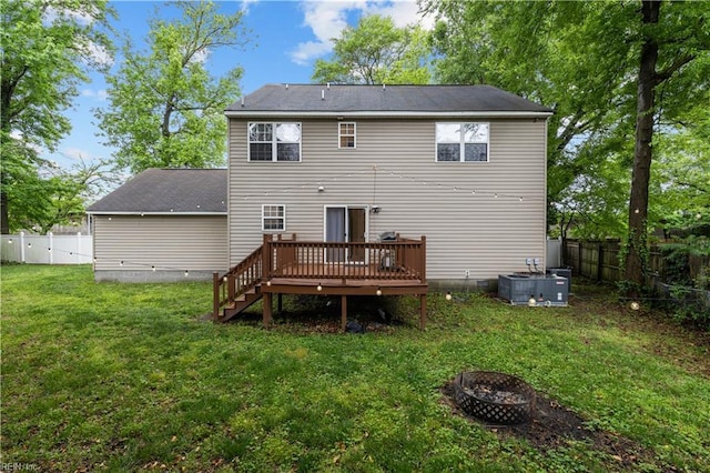 390 Naval Base Rd, Norfolk, VA 23505 - back of property featuring a fire pit, a lawn, a wooden deck, central AC unit, and a fenced backyard