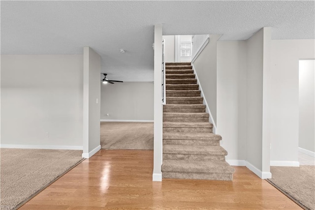 390 Naval Base Rd, Norfolk, VA 23505 - stairway featuring a textured ceiling, wood finished floors, ceiling fan, and carpet floors
