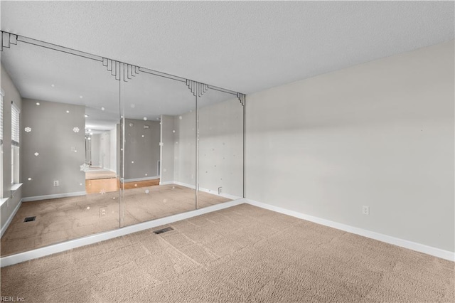 390 Naval Base Rd, Norfolk, VA 23505 - spare room with a textured ceiling, carpet floors, baseboards, and visible vents