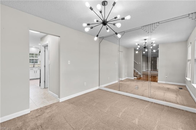 390 Naval Base Rd, Norfolk, VA 23505 - unfurnished bedroom with a textured ceiling, a notable chandelier, carpet, and baseboards