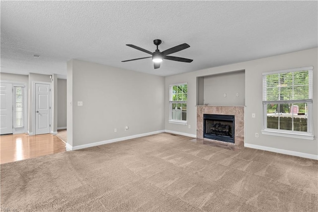 390 Naval Base Rd, Norfolk, VA 23505 - unfurnished living room featuring a textured ceiling, baseboards, a ceiling fan, and carpet floors