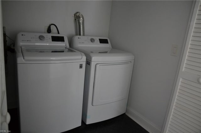 clothes washing area featuring separate washer and dryer