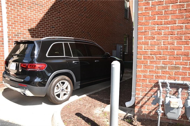 exterior details featuring brick siding and gas meter