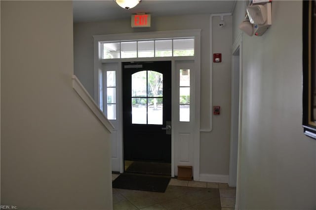 foyer with light tile patterned floors and baseboards