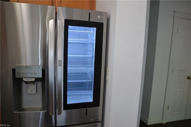 details featuring stainless steel fridge with ice dispenser