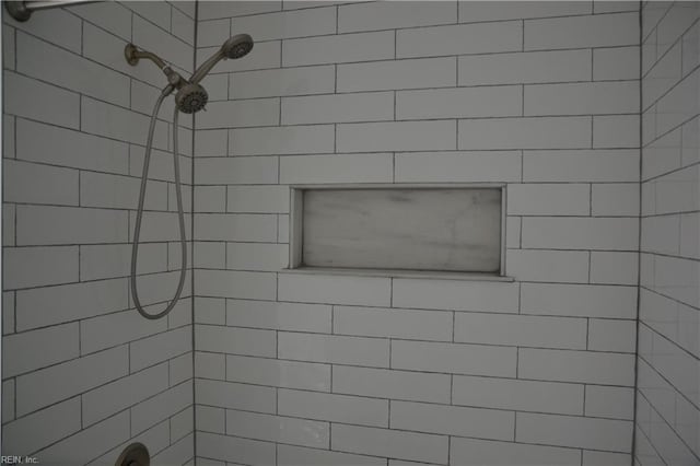 full bath featuring tiled shower