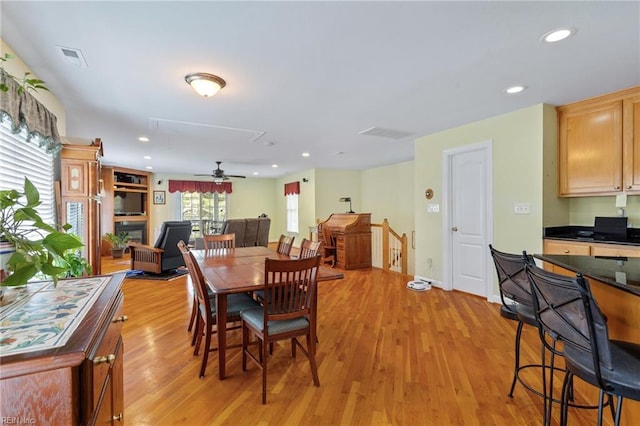 dining space with attic access, visible vents, recessed lighting, light wood finished floors, and a ceiling fan