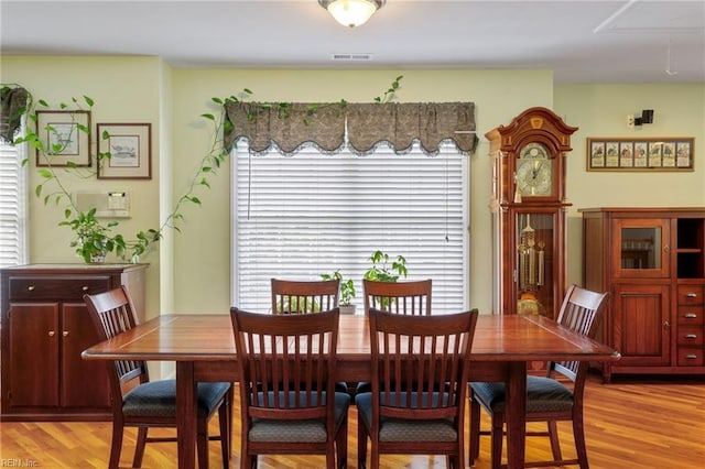 dining room featuring light wood-style flooring and visible vents