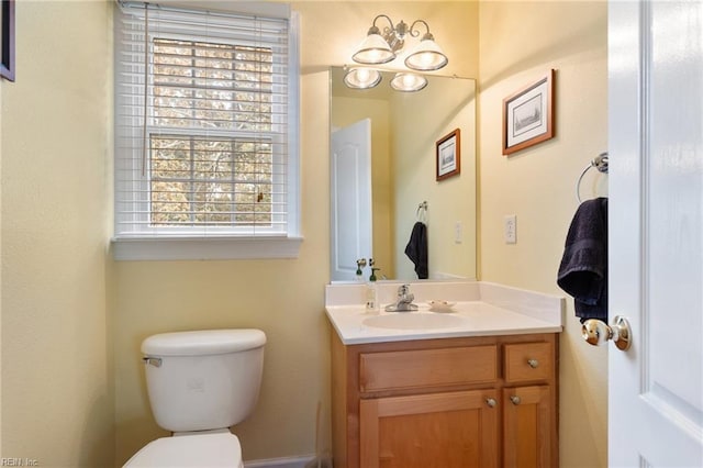 half bathroom featuring toilet and vanity