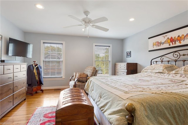 bedroom featuring recessed lighting, light wood-type flooring, and multiple windows