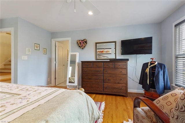 bedroom with ceiling fan and light wood-style floors