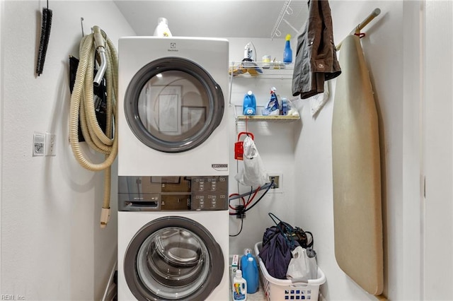 washroom featuring laundry area and stacked washer / dryer