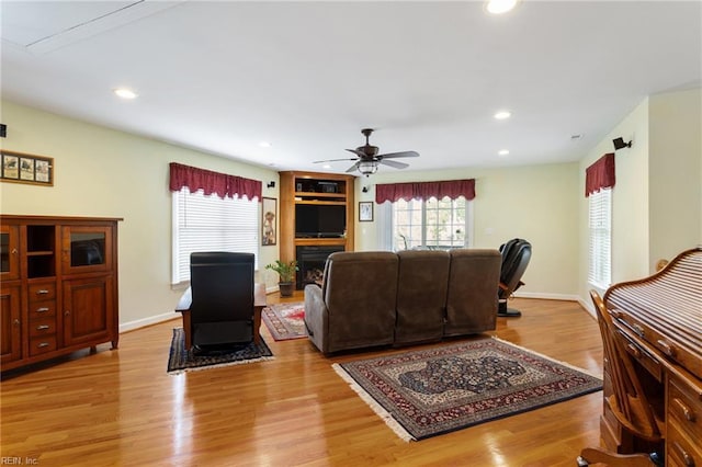 living room with ceiling fan, recessed lighting, baseboards, and wood finished floors