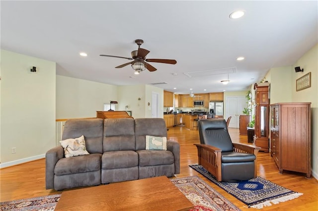 living room featuring attic access, recessed lighting, light wood finished floors, a ceiling fan, and baseboards