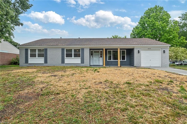 single story home with covered porch, concrete driveway, an attached garage, and a front lawn
