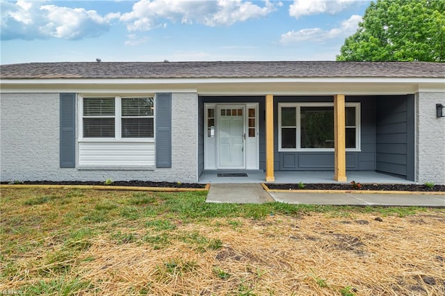 exterior space featuring a porch and a front lawn